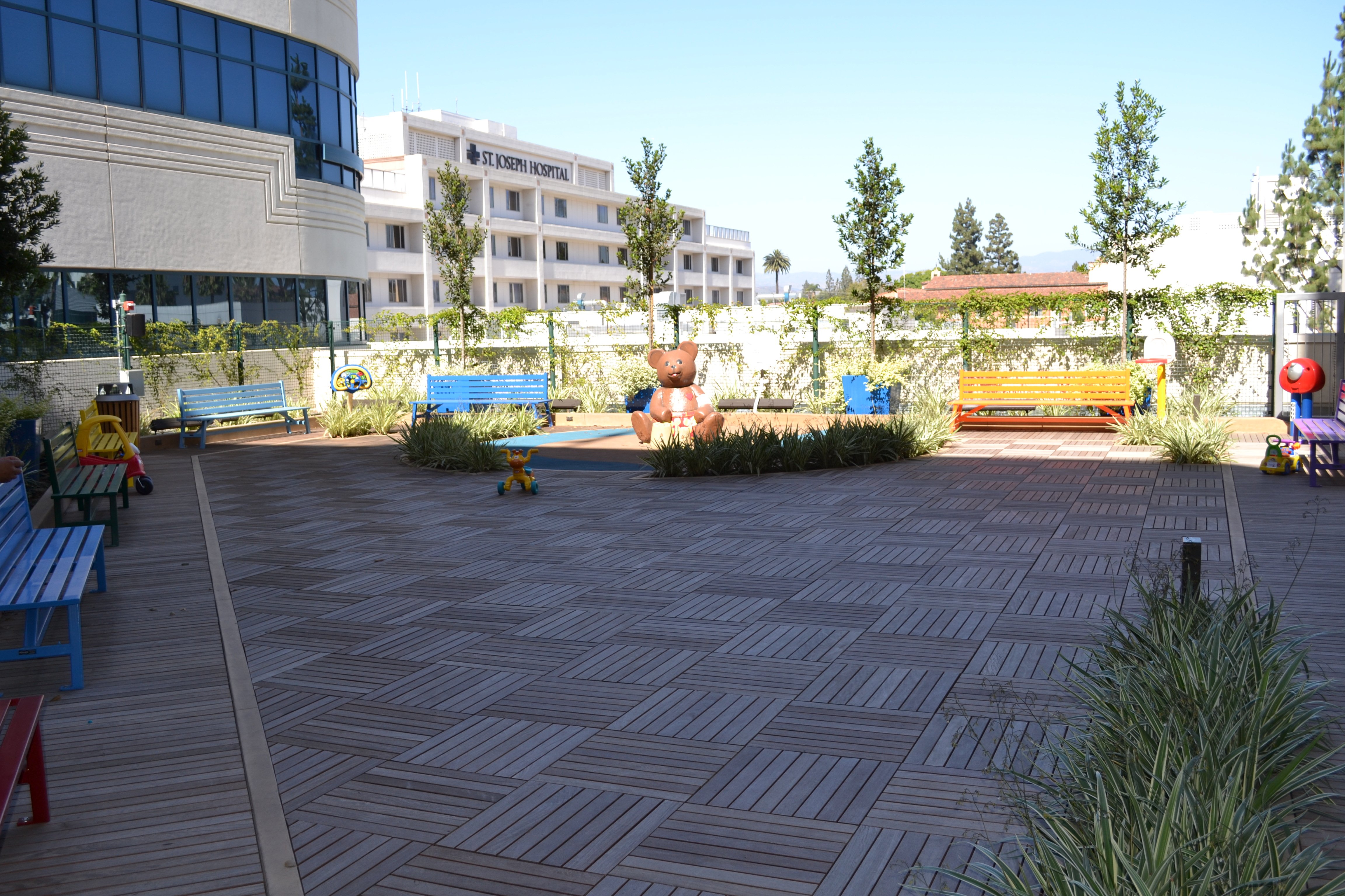 Children's play area with planters on a hospital rooftop deck